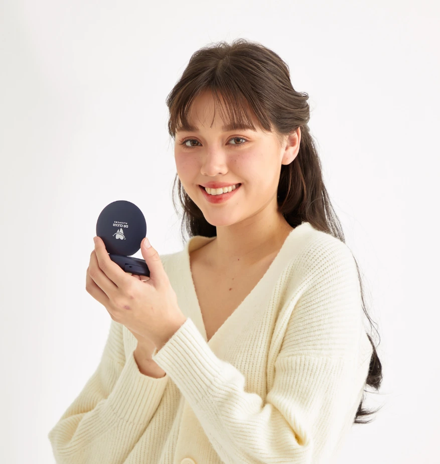 Woman smiling while holding a Dr Clear Aligners case