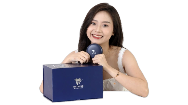 Smiling woman posing with Dr Clear Aligners box and aligner case.