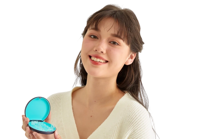 Smiling woman holding a Dr Clear Aligners case with clear aligners inside