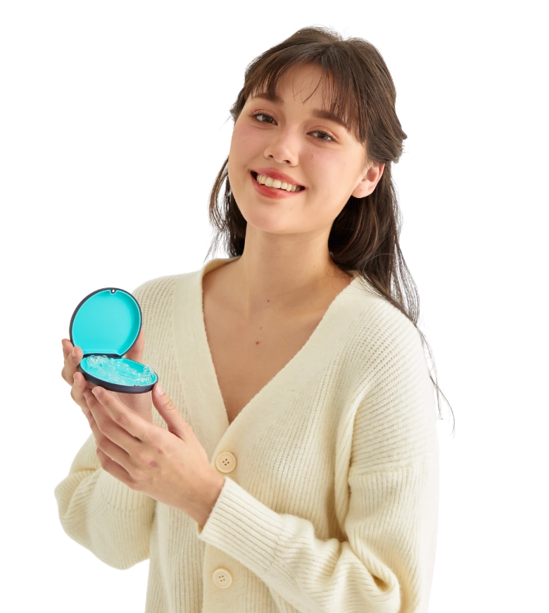 Smiling woman holding a Dr Clear Aligners case with clear aligners inside